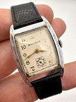 Front view showing dial, case engraving, strap