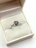 Ring in jewellery box showing pearl and diamond spiral setting