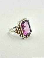 Ring front showing purple glass stone and silver stepped bezel