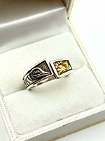 Ring front showing gold nugget inlay and Coast Salish carving