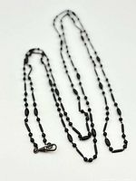Full length view of folded black jet pocket-watch chain and clasp