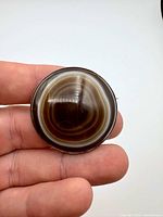 Front view showing concentric banded agate cabochon and silver bezel