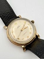 Front view of Cyma Tavannes watch showing dial, hands, and strap