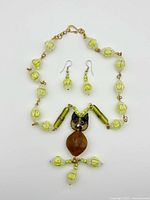 Full view of necklace and earrings on white background