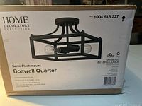 Box front showing product name, brand, model, size and image of fixture