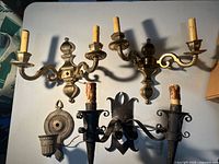 Top view of five assorted metal wall sconces