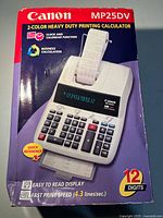 Front of retail box displaying Canon MP25DV calculator image and features
