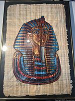 Front view of framed papyrus artwork showing pharaoh mask illustration