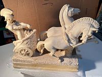 Full view of marble Roman chariot sculpture on base