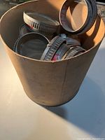 Cardboard tub filled with multiple metal sieves