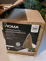 Front of retail box showing NOMA branding and Kensington 7' pre-lit tree details