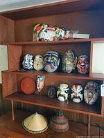 Entire lot on shelving showing masks, hats, tray, hagoita, bagged doll