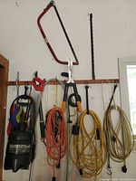 Overall view of tools and cords hanging on rack
