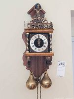 Front view of Dutch Zaanse wall clock with twin brass pear weights