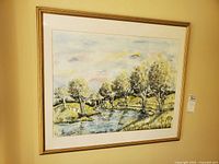Full view of framed watercolor landscape on wall