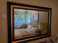 Front view of framed wall mirror showing full frame and reflection