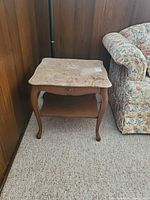 Full view of table beside floral sofa