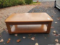 Top view of rectangular wood coffee table showing veneer pattern and lower shelf