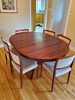 Table extended with six chairs around it