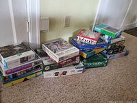 Entire lot of stacked puzzle and game boxes