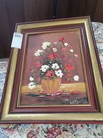 Full view of framed floral still life painting