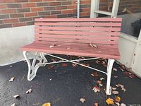 Front view of bench showing wood slats and cast metal sides