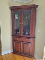 Full view of corner china cabinet showing upper and lower sections