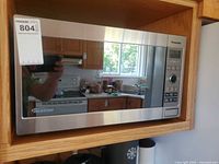 Front view of Panasonic stainless steel inverter microwave installed in cabinet