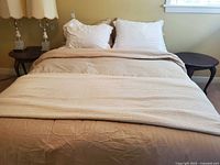 Bed made up showing overall size of mattress