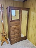 Front view showing two mirrored doors and five drawers