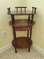Full view of three-tier wooden side table