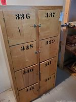 Front view of cabinet showing all eight numbered doors and hardware