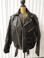 Front view showing lapels, zippers, belt, pockets