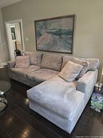 Full view of sectional showing right chaise and overall light gray microsuede upholstery