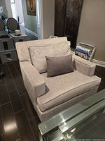 Front view of ELTE Berrington armchair with cushions