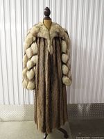 Front view of full-length mink coat on dress form