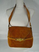 Front view of Gucci camel suede shoulder bag showing flap and gold-tone G buckle