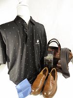 Group shot of polo, loafers, bag, tie, pocket square, suspenders