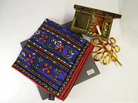 Lot overview showing silk scarf, gold-tone compact, comb, vial and hair barrette