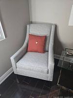 Front angled view of chair showing upholstery, arms, seat