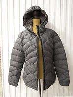 Front view of charcoal Paradox hooded puffer jacket on mannequin, zipper partly open