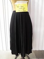 Front view of black Ralph Lauren knife-pleat skirt on mannequin