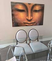 Two chairs under glass table showing upholstery and frame colour