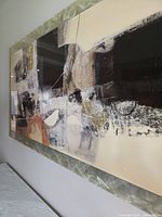 Oblique close-up of artwork showing abstract forms, colours and frame edge