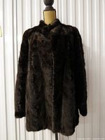Front view of dark brown mink fur jacket on mannequin