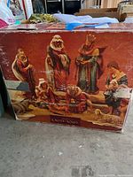Front of boxed 9-piece nativity set showing figure images and branding