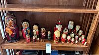 All four nesting doll sets displayed on shelf