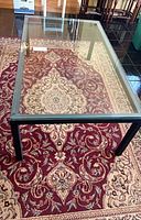 Top view of rectangular glass coffee table on rug