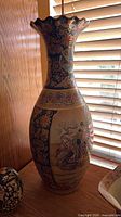 Full view of tall ceramic vase with Asian motif
