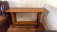 Front view of Mission style wood side table between sofa and wall